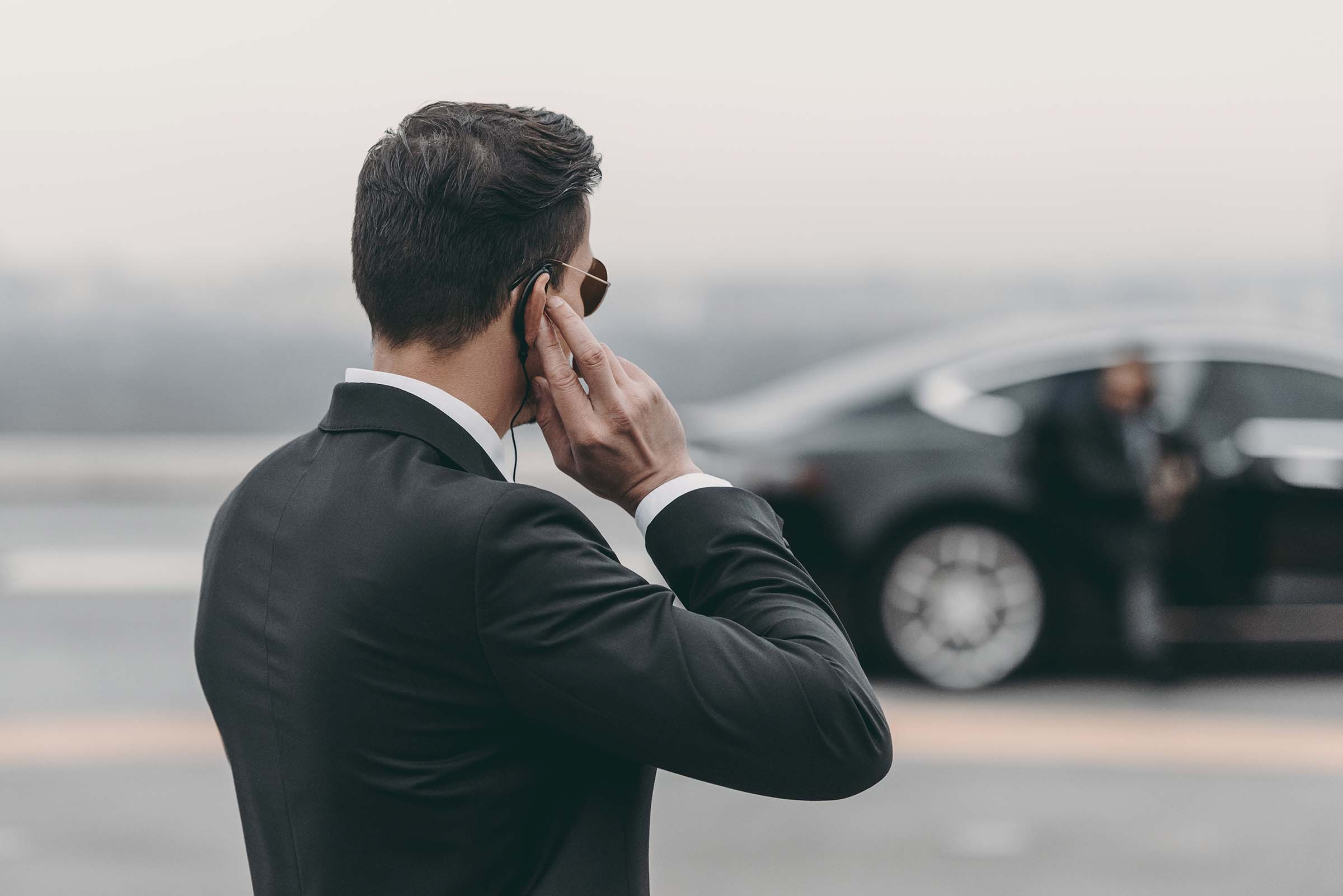 handsome-bodyguard-standing-and-listening-message-A78BNHN.jpg